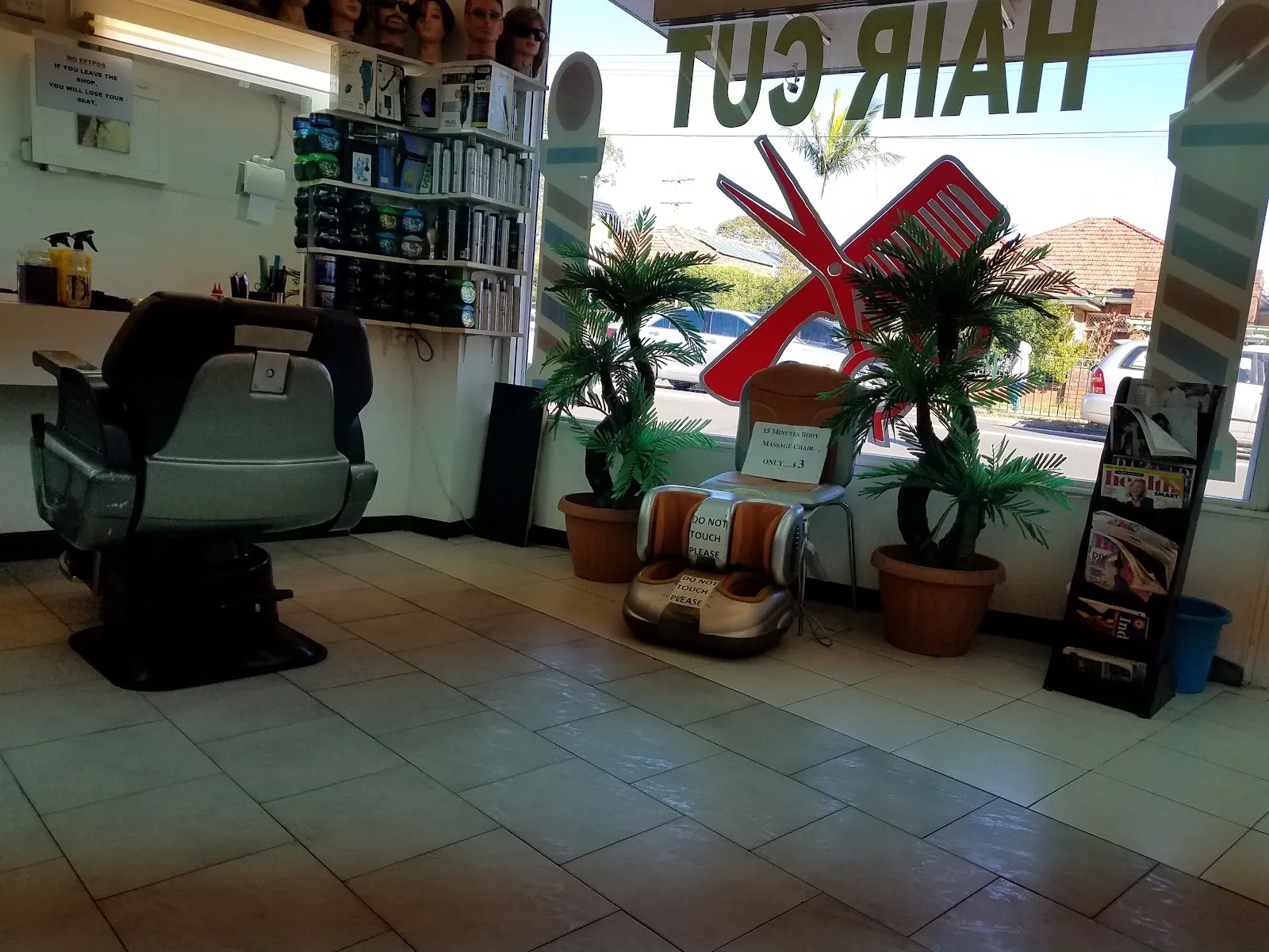 A barber chair and potted plants inside the salon